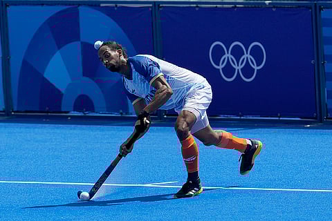 Hardik Singh hits a shot against Argentina